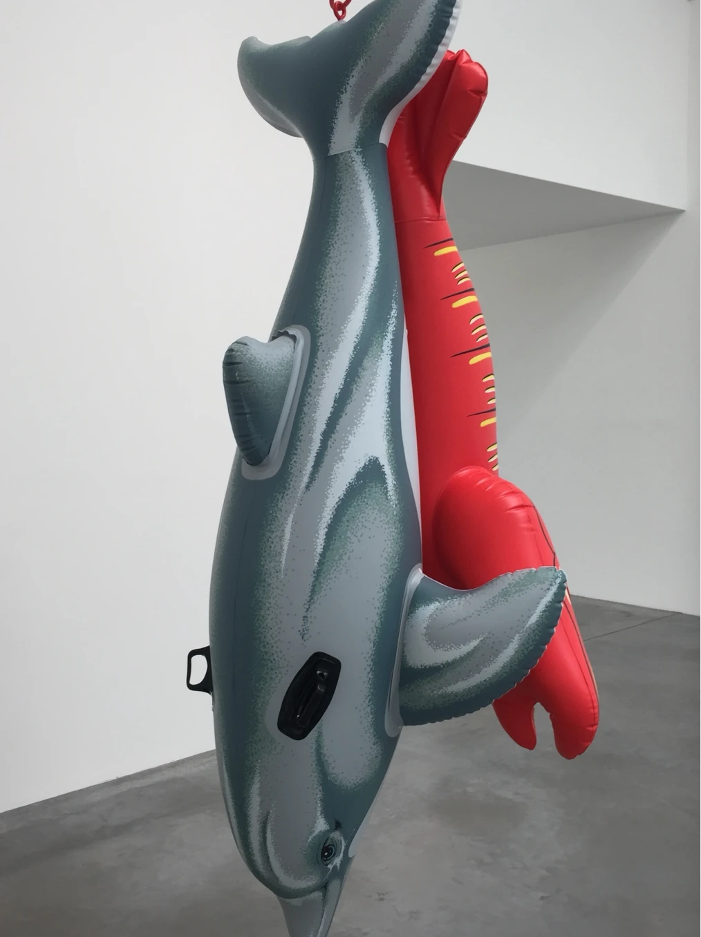 Hanging dolphin sculpture with a red lobster